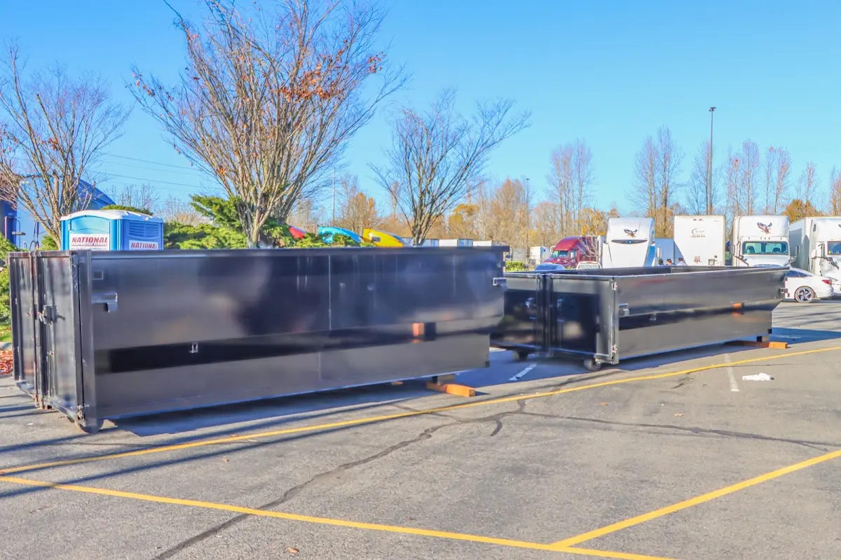 Professional dumpster rental service with roll-off container on residential driveway in Harwinton